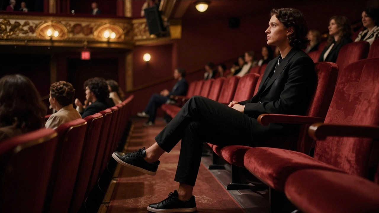 Audience member in black sneakers sitting comfortably in theater